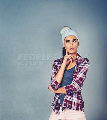 Buy stock photo Shot of an attractive and quirky young woman posing in the studio
