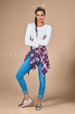 Buy stock photo Studio shot of a young woman wearing costume rabbit ears against a plain background