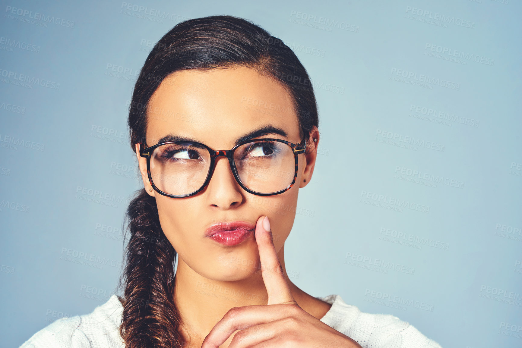 Buy stock photo Thinking, glasses and woman with question in studio for future, vision or planning with mockup space. Ideas, solution and female person with guess, brainstorming or decision by blue background.