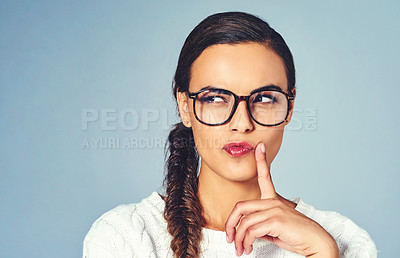 Buy stock photo Ideas, glasses and woman with question in studio for future, vision or planning with mockup space. Thinking, solution and female person with guess, brainstorming or decision by blue background.