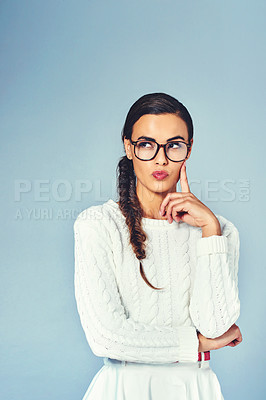 Buy stock photo Thinking, glasses and woman with brainstorming in studio for future, vision or planning with mockup space. Ideas, solution and female person with guess, question or decision by blue background.