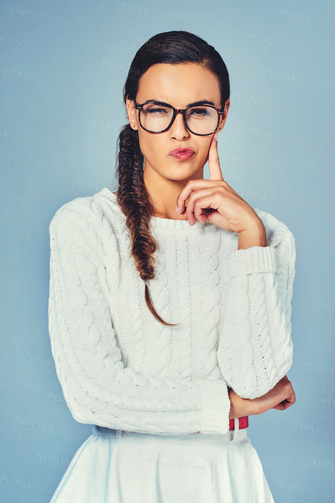 Buy stock photo Thinking, glasses and portrait of woman in studio for future, vision or planning with wink face. Question, solution and female person with guess, brainstorming or decision by blue background.