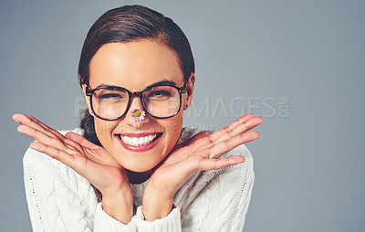 Buy stock photo Woman, flower and spectacles in studio portrait, eye care and sustainable frames for optometry. Female person, mockup space and proud for eco friendly glasses, spring optical lens and gray background