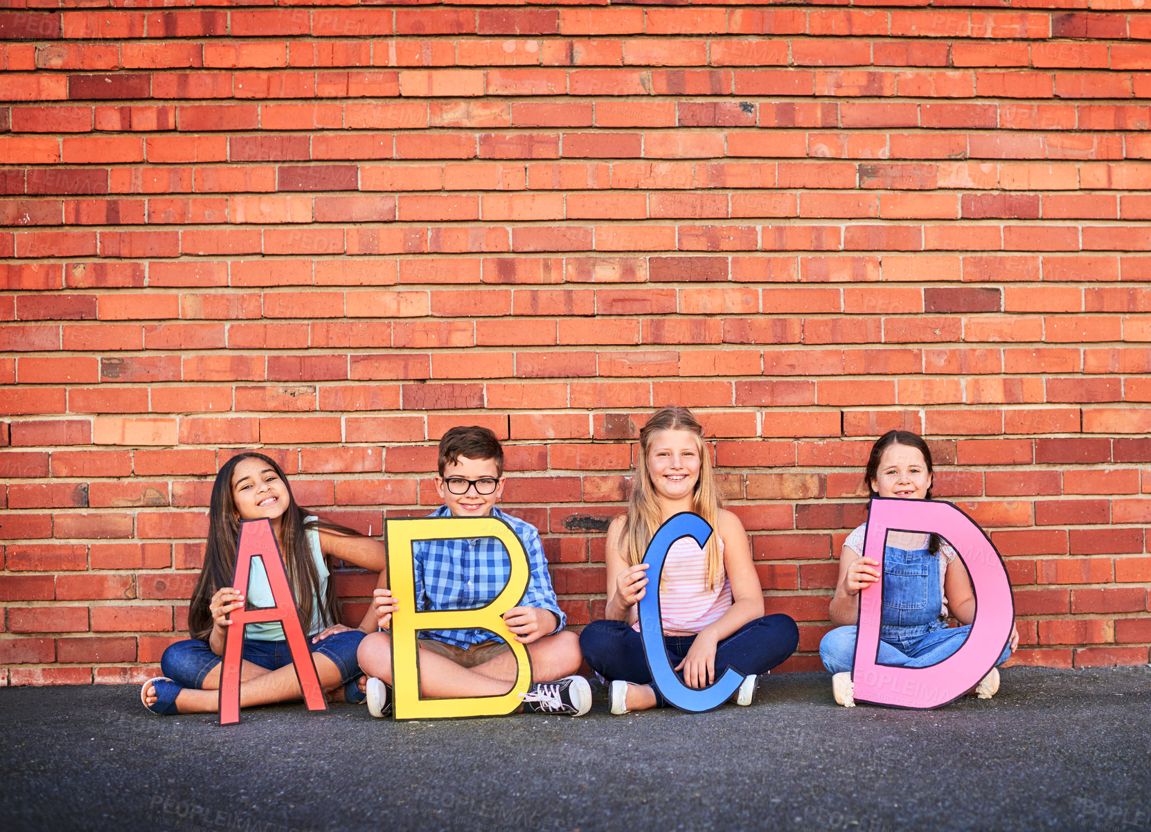 Buy stock photo Portrait, education and letters with children and wall background for growth, learning and alphabet. Future, knowledge and friends with group of students at school for language, academy and reading