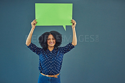 Buy stock photo Mockup, poster and woman portrait with speech bubble in studio for news or social media blue background. Space, voice and female person advertising opinion with paper, sticker and branding promotion