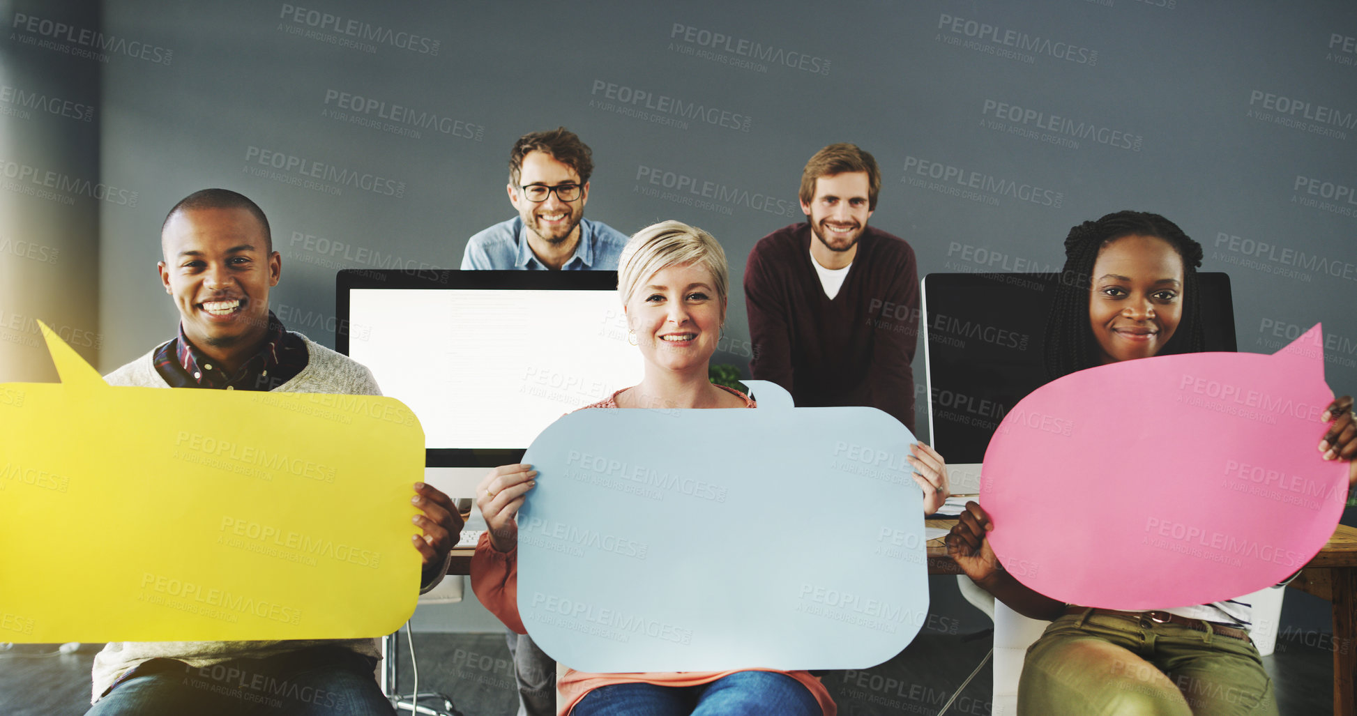 Buy stock photo Shot of a diverse group of people holding up speech bubbles in a modern office