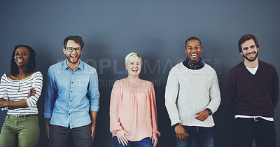 Buy stock photo Studio shot of a diverse group of people standing together against a gray background