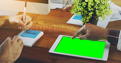 Buy stock photo Shot of an unrecognisable businessperson working on a digital tablet with a chroma key screen