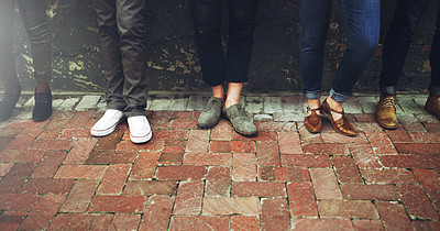 Buy stock photo Cropped shot of a diverse group of people standing together on a paved sidewalk