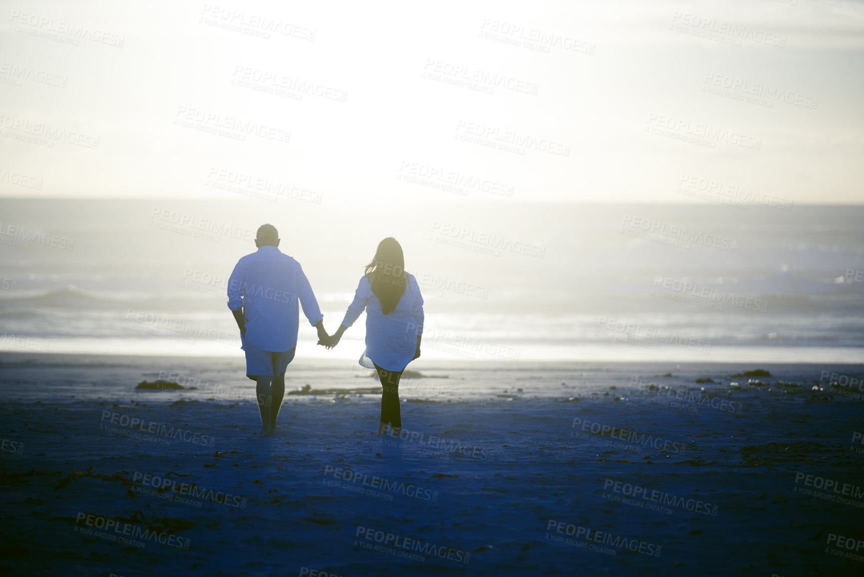 Buy stock photo Shot of a mature couple going for a relaxing walk on the beach