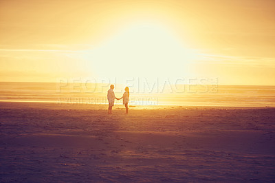 Buy stock photo Full length shot of an affectionate mature couple standing face to face and hand in hand on the beach