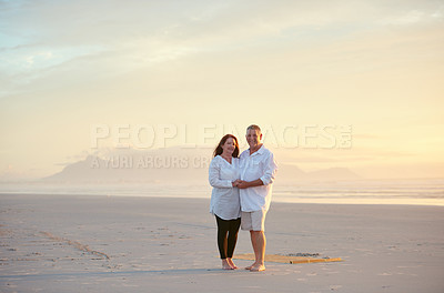 Buy stock photo Shot of mature people enjoying the sunset on the beach