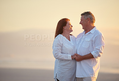 Buy stock photo Shot of mature people enjoying the sunset on the beach