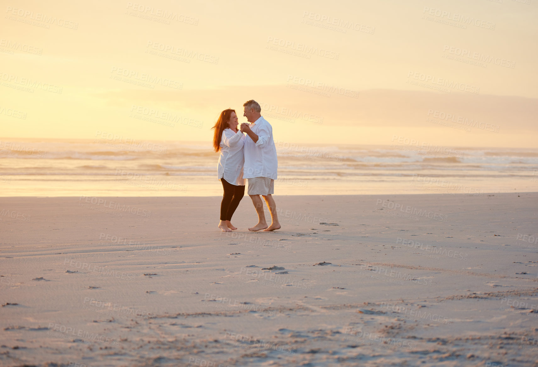 Buy stock photo Shot of a mature couple dancing on the beach