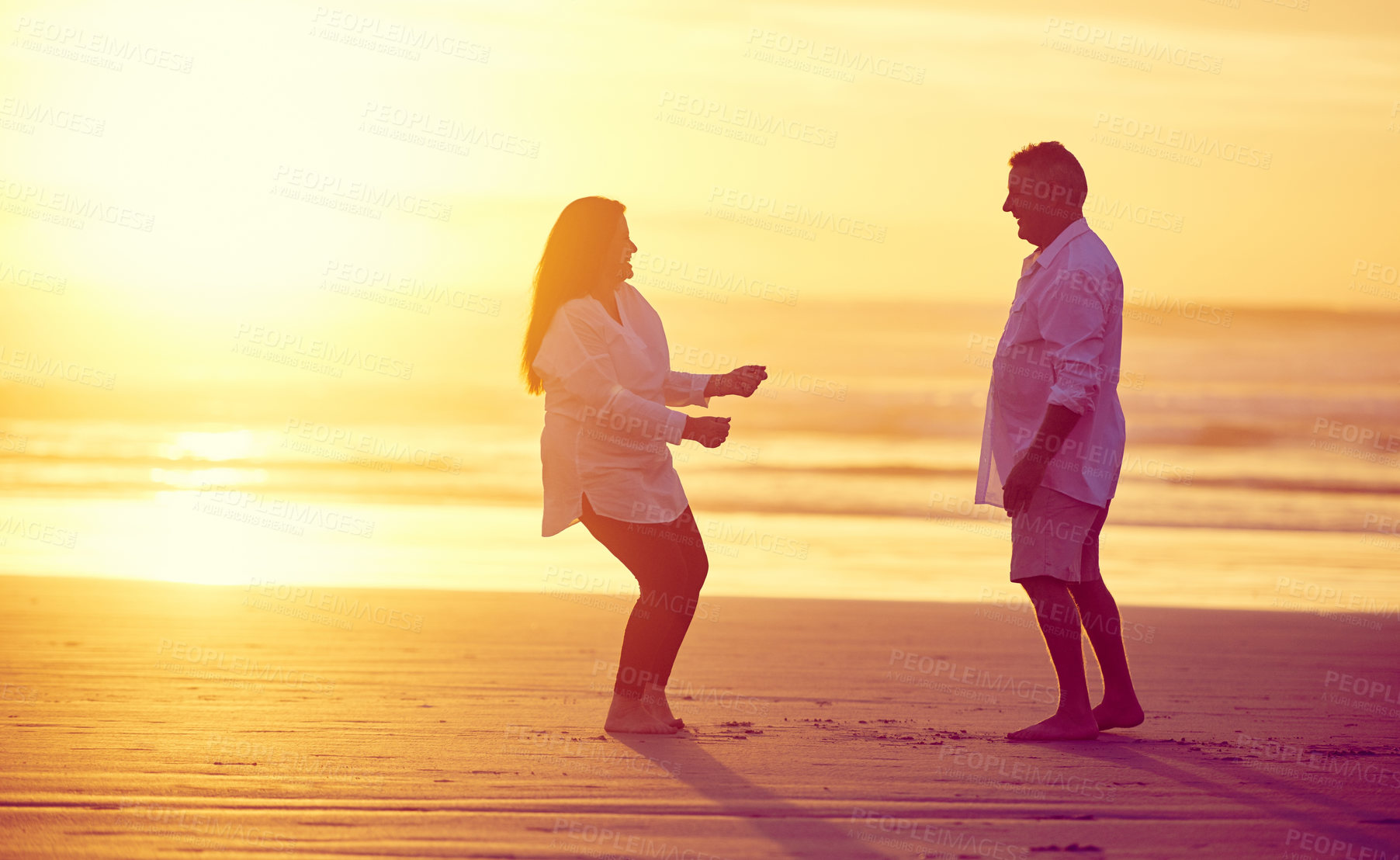 Buy stock photo Full length shot of an affectionate mature couple dancing on the beach at sunset