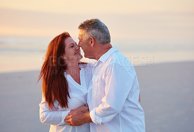 Buy stock photo Shot of mature people enjoying the sunset on the beach