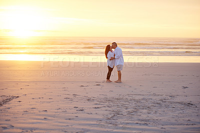 Buy stock photo Shot of a mature couple kissing on the beach