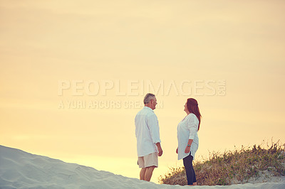 Buy stock photo Shot of mature people standing on a sand dune at the beach