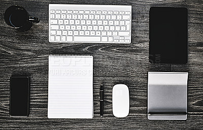 Buy stock photo High angle shot of a variety of wireless devices on a work desk