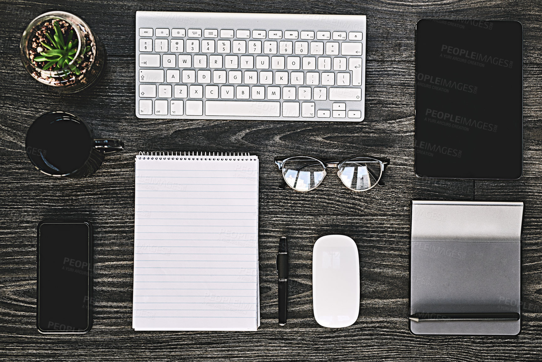 Buy stock photo High angle shot of a variety of wireless devices on a work desk