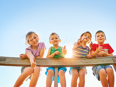 Buy stock photo Portrait of a group of little children showing thumbs up while playing together outdoors