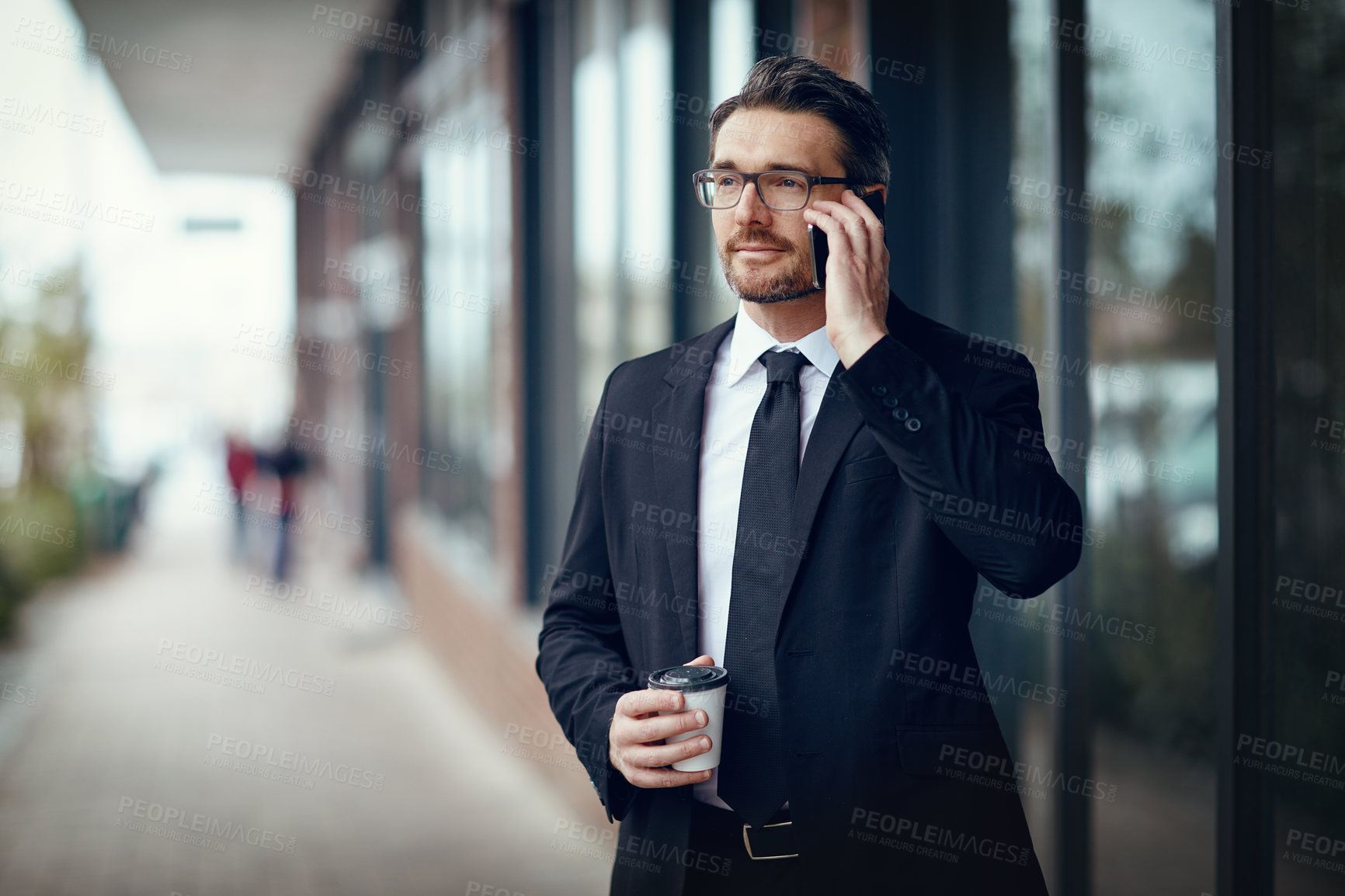 Buy stock photo Shot of a mature businessman talking on cellphone while out in the city