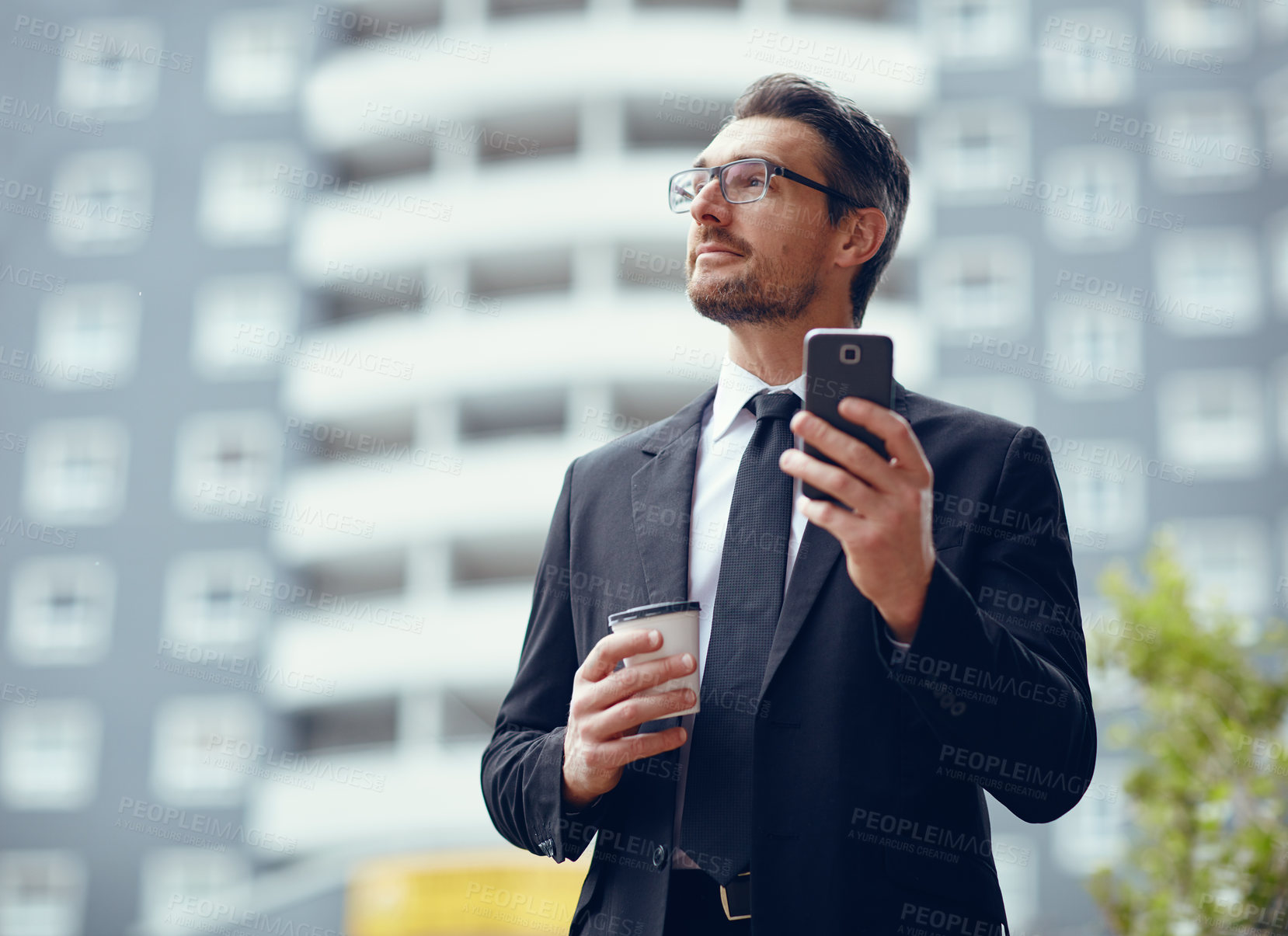 Buy stock photo Shot of a mature businessman texting on a cellphone while out in the city