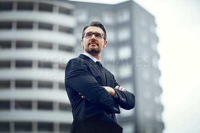 Buy stock photo Shot of a mature businessman looking thoughtful while standing in the city