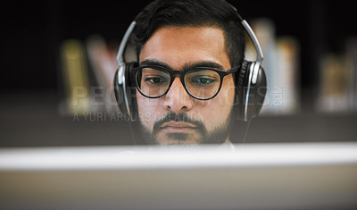 Buy stock photo Man, education and computer lab in university with headphones, project and deadline in IT course. Male person, technology and scholarship in college with desktop, assignment and software for research