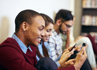 Buy stock photo Cropped shot of university students social networking on campus