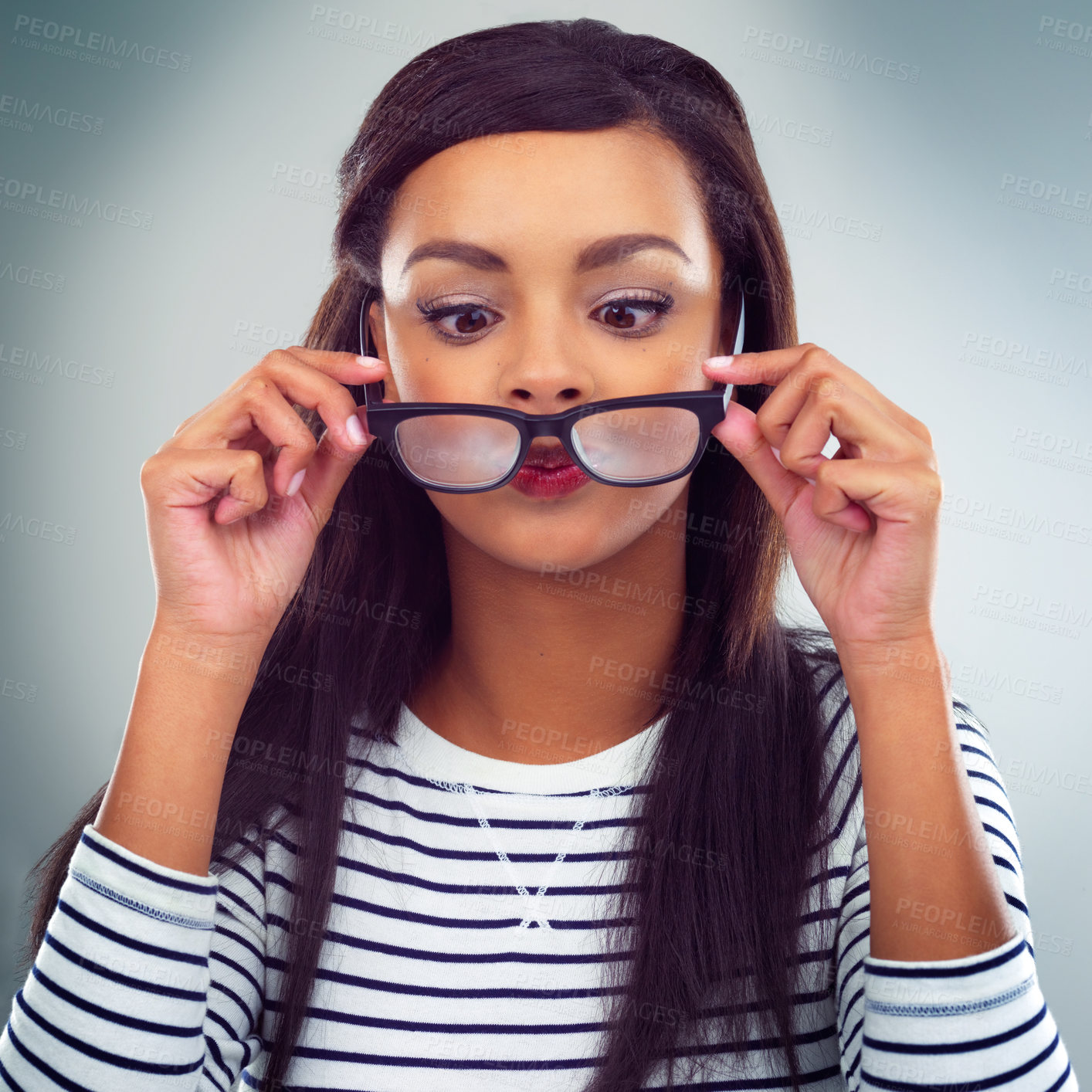 Buy stock photo Shot of a young woman posing against a grey background