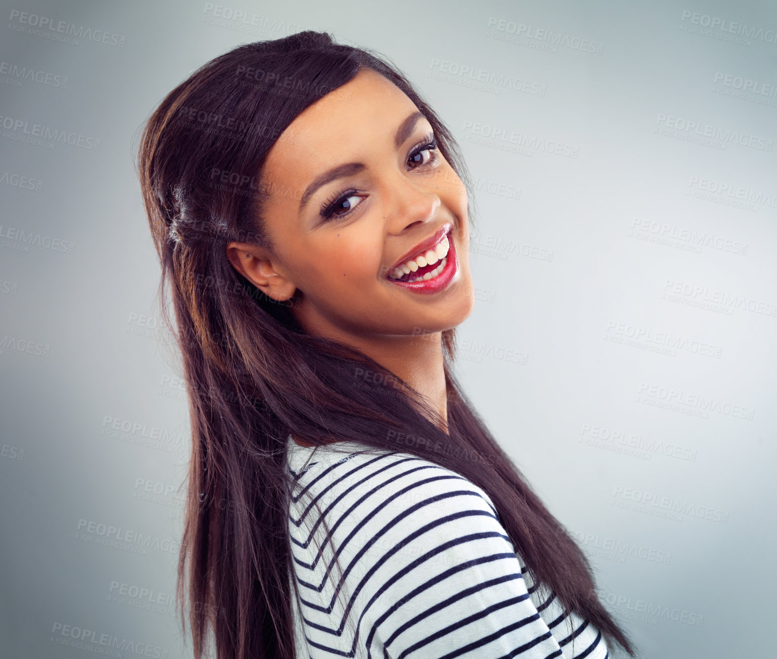 Buy stock photo Shot of a young woman posing against a grey background