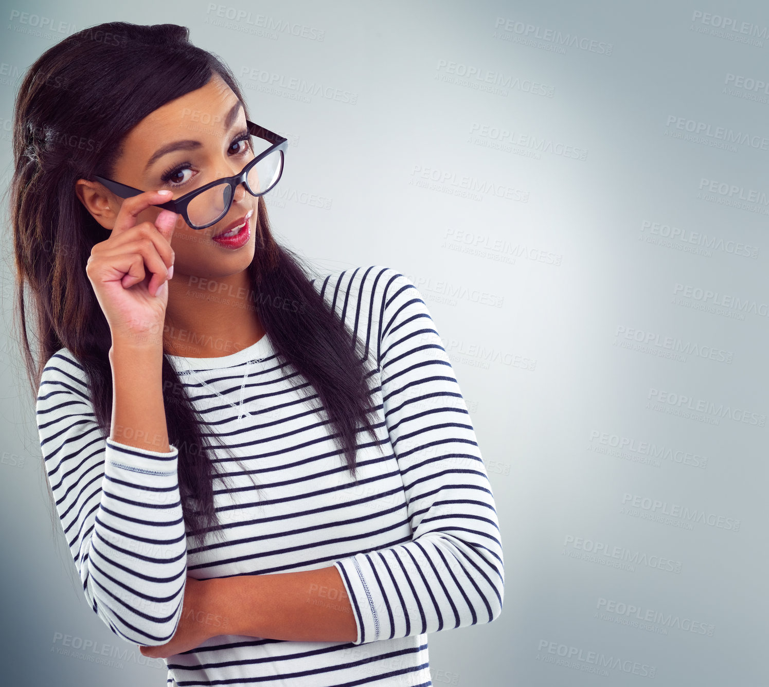 Buy stock photo Shot of a young woman posing against a grey background