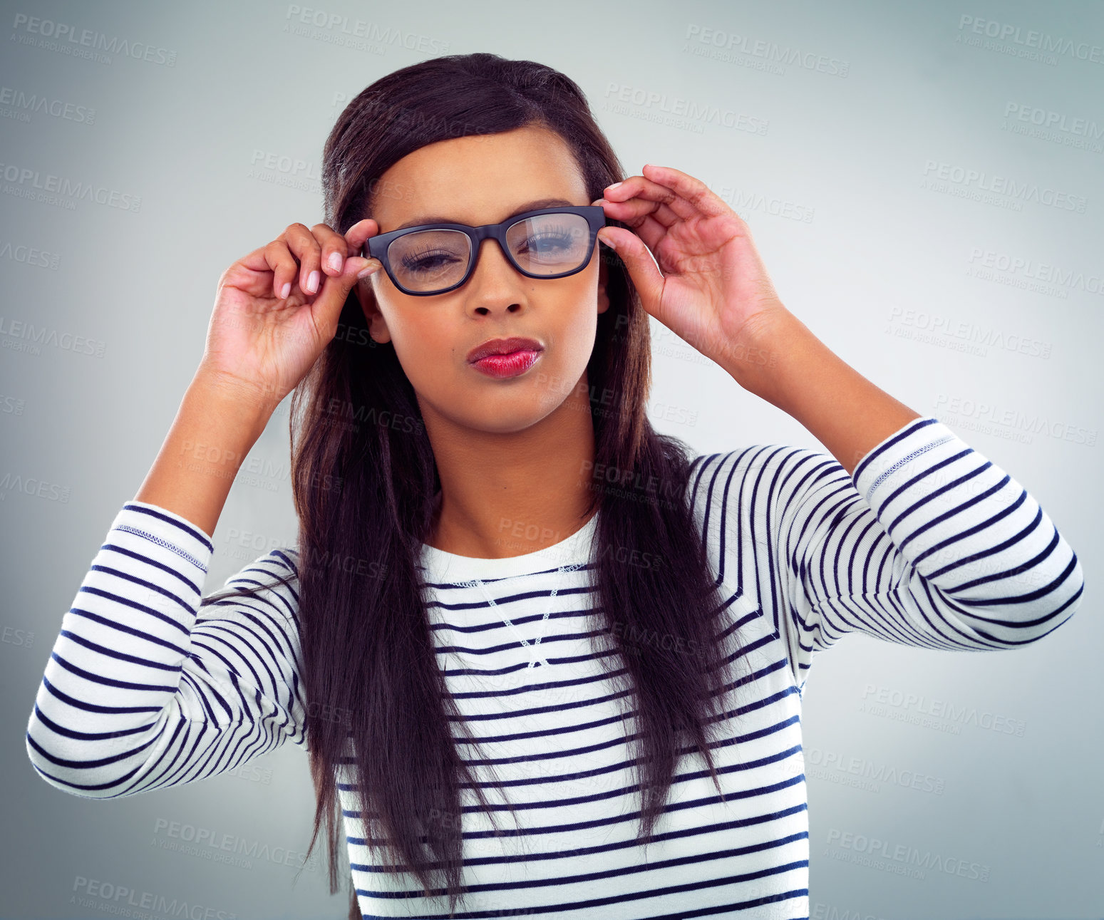 Buy stock photo Shot of a young woman posing against a grey background