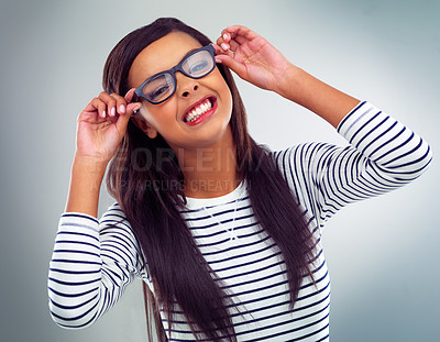 Buy stock photo Shot of a young woman posing against a grey background