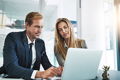 Buy stock photo Cropped shot of two businesspeople working together on a laptop