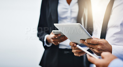Buy stock photo Cropped shot of unrecognizable businesspeople using their wireless devices in the office