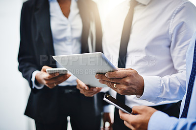 Buy stock photo Cropped shot of unrecognizable businesspeople using their wireless devices in the office