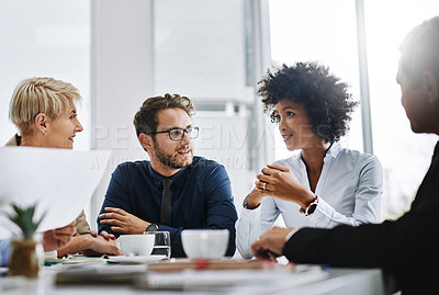 Buy stock photo Shot of a group of businesspeople sitting together in a meeting