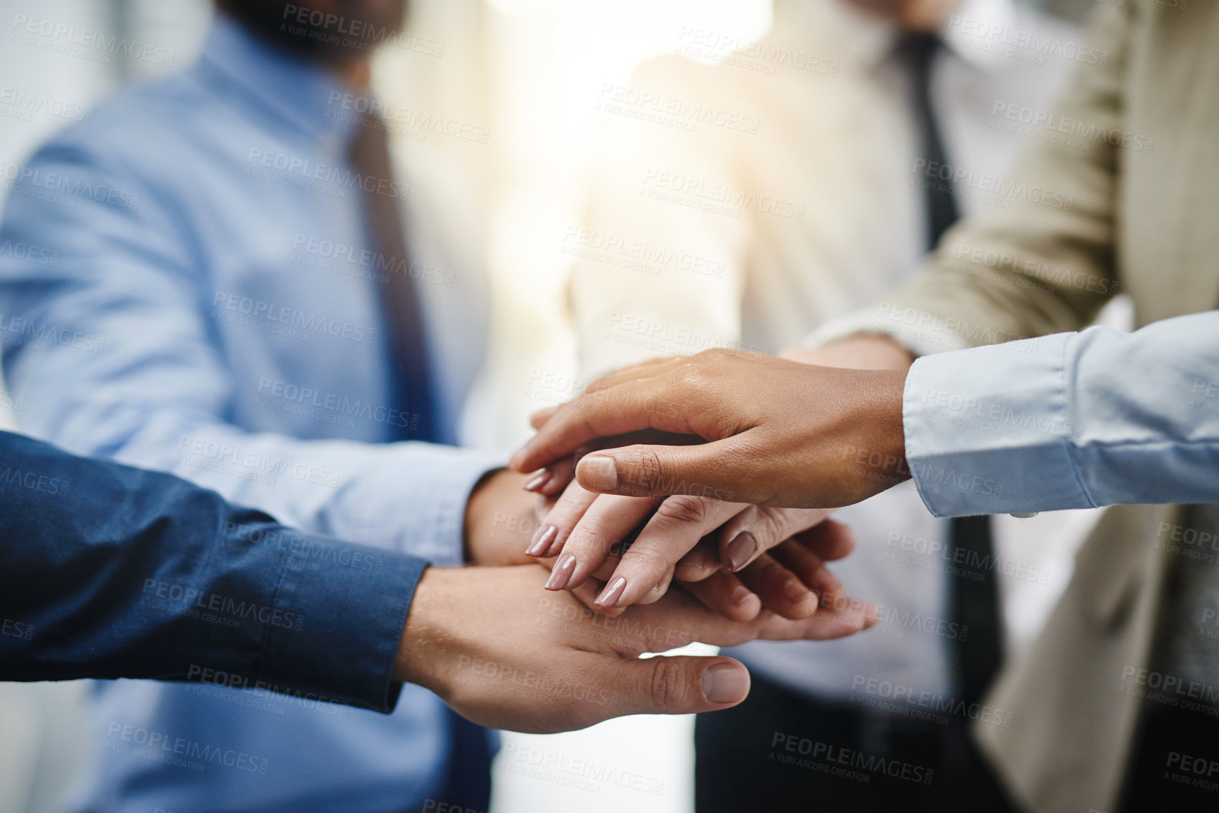 Buy stock photo Cropped shot of a group of businesspeople putting their hands together in unity