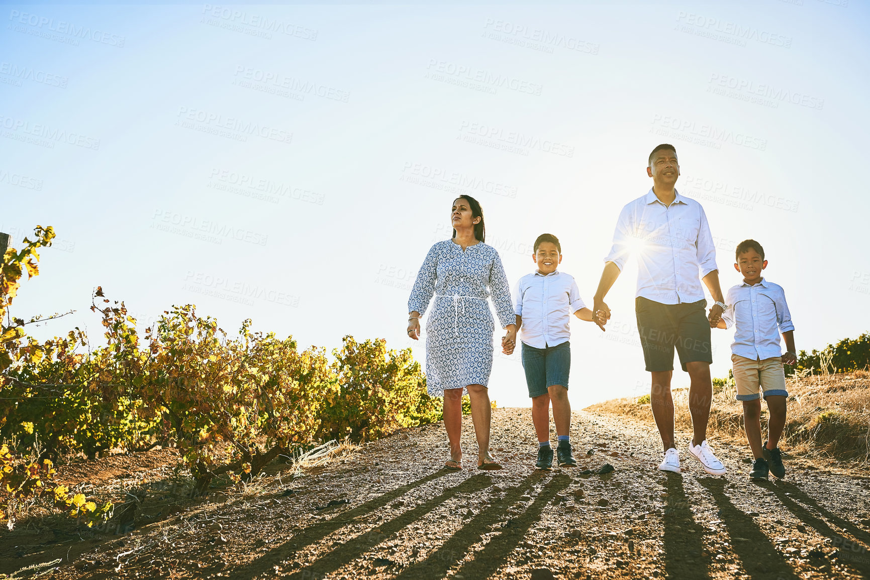 Buy stock photo Shot of a happy family bonding together outdoors