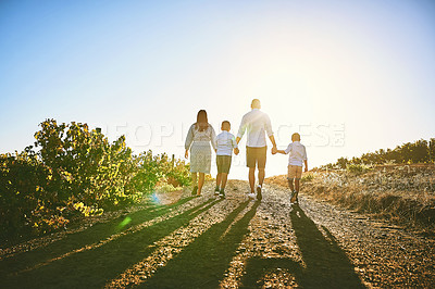 Buy stock photo Rearview shot of a family bonding together outdoors