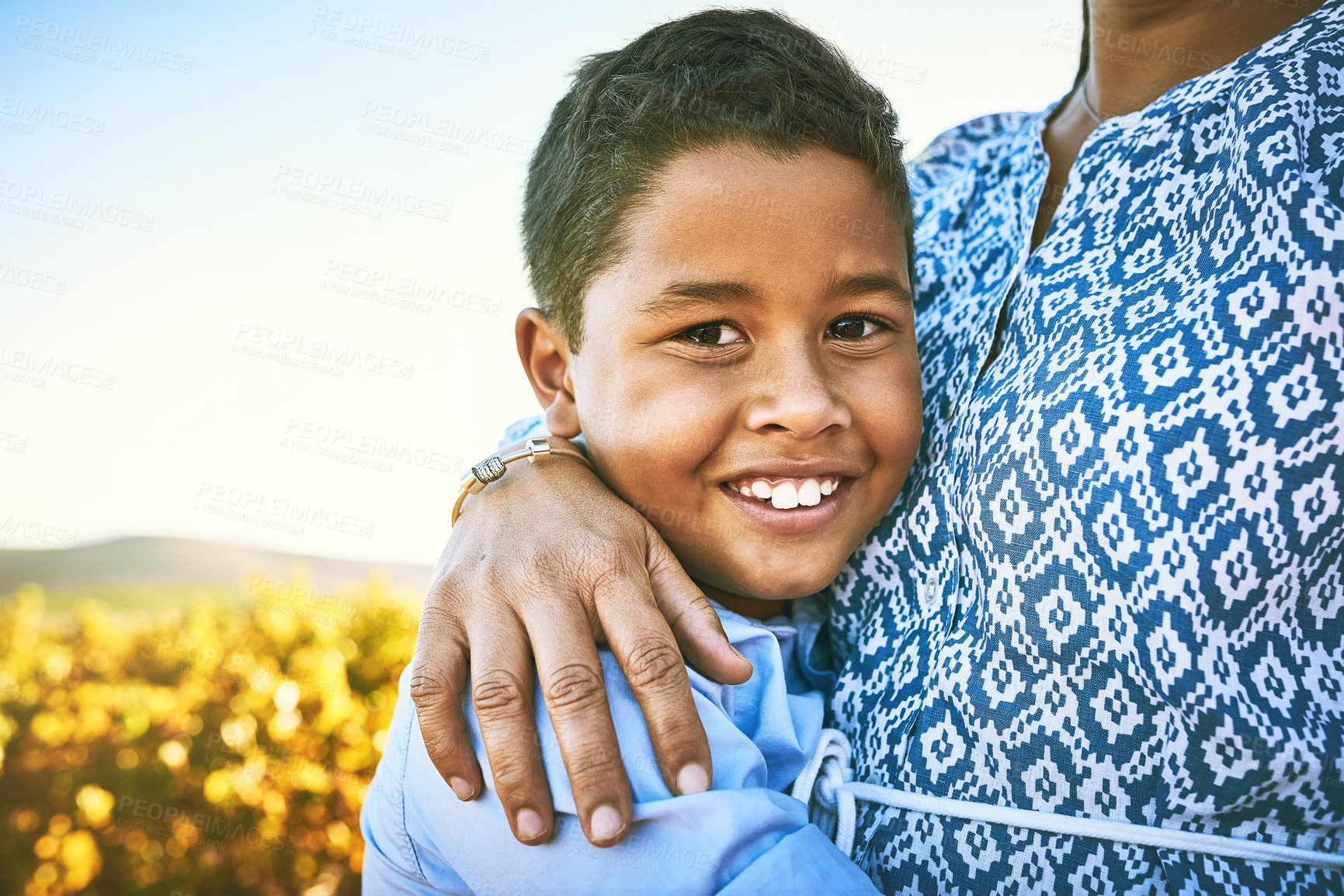 Buy stock photo Portrait of a little boy hugging his mother outdoors
