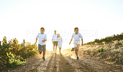 Buy stock photo Shot of a happy family bonding together outdoors