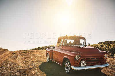 Buy stock photo Shot of a cheerful young family driving in a red pickup truck on a rural road outside
