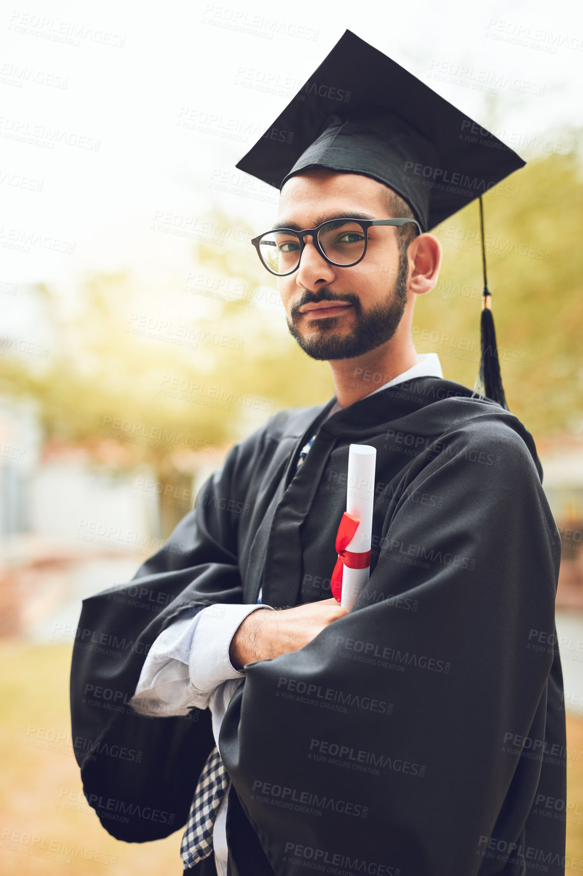 Buy stock photo Happy man, portrait or graduate with certificate for graduation, diploma or degree at university. Young, male person or student with arms crossed for confidence, qualification or academic achievement