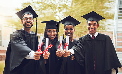 Buy stock photo Shot of a group of fellow students standing together on graduation day