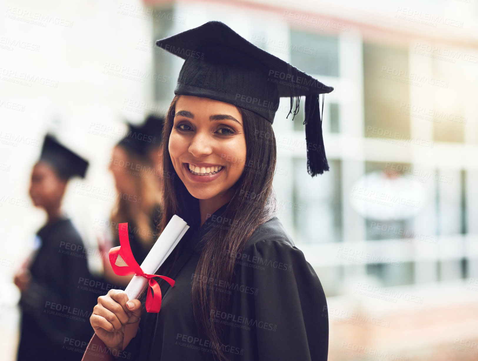 Buy stock photo Cropped shot of a happy young graduate standing outside