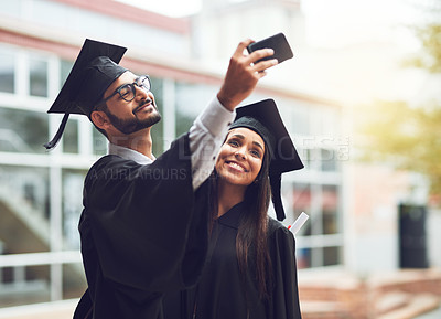 Buy stock photo Cropped shot of two graduates taking a selfie together