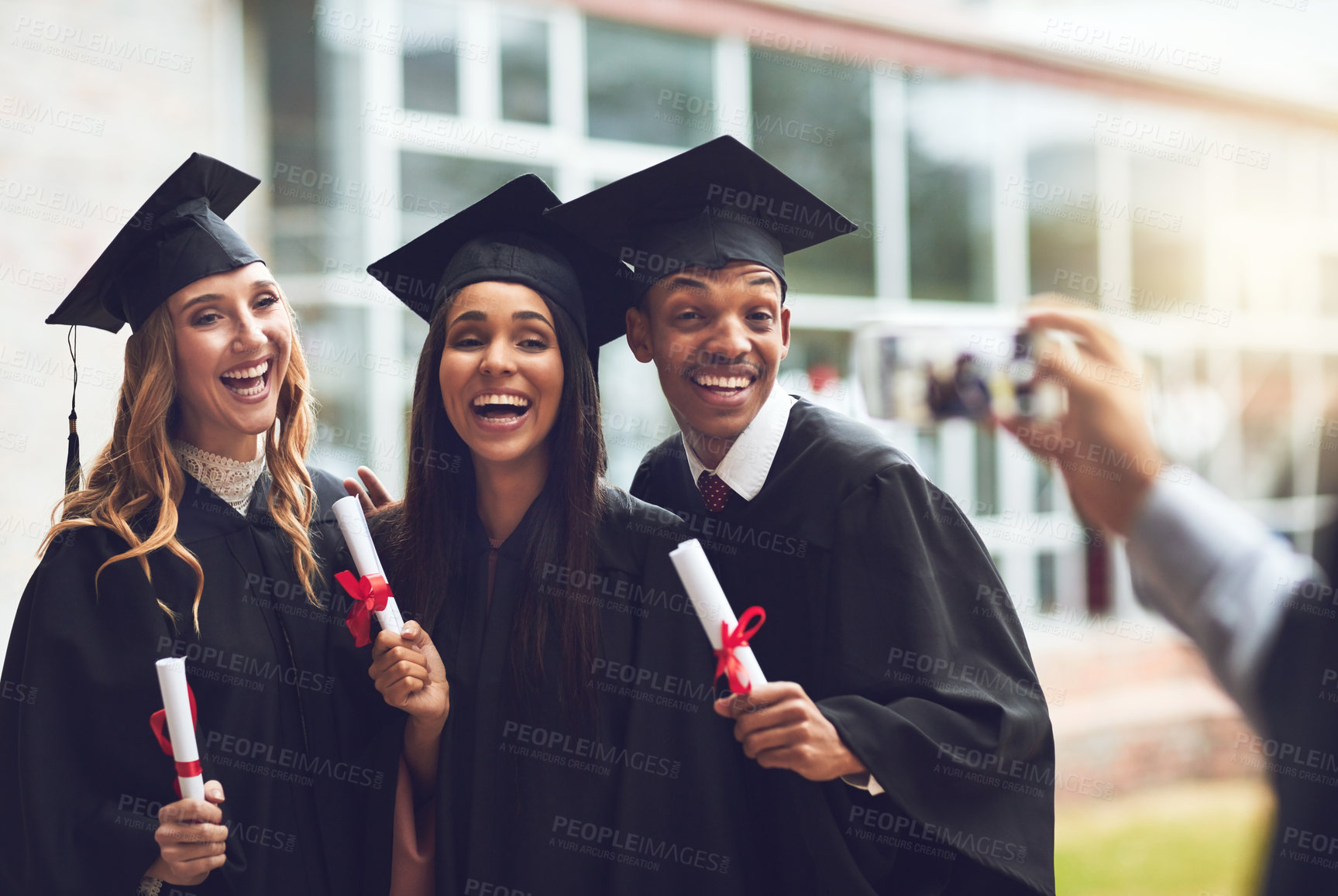 Buy stock photo Cropped shot of fellow students taking a picture together on graduation day